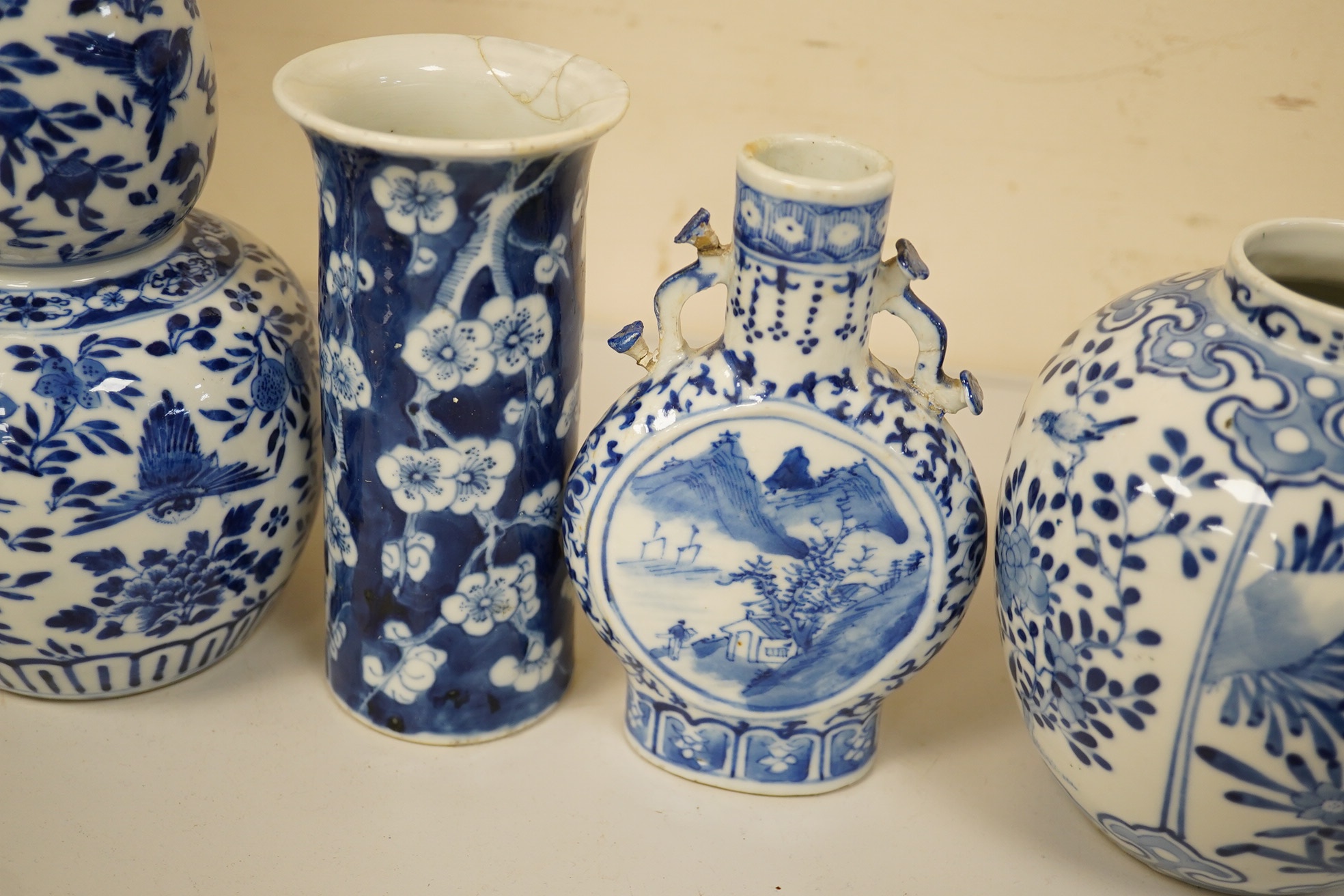Four 19th century Chinese blue and white jars / vases, including a moon flask and double gourd vase, largest 23cm high. Condition - poor